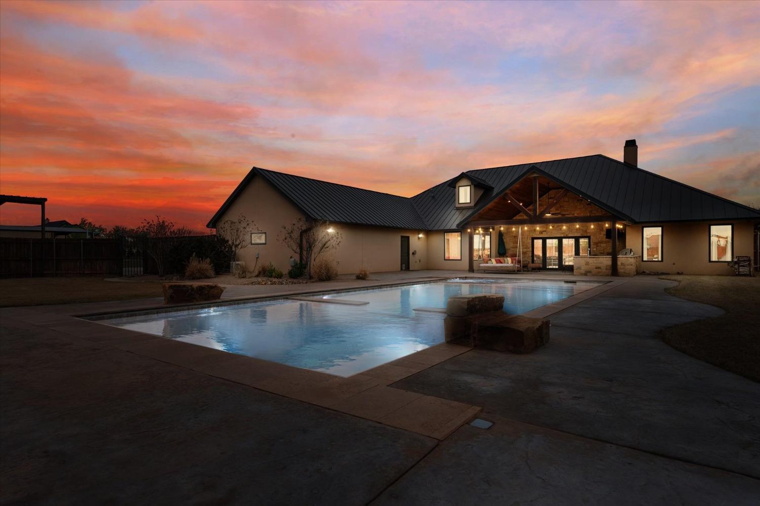 This stunning home in Shallowater ISD features 4 bedrooms, 4 bathrooms, a 3 car garage, and a 50 x 60 shop with an overhead garage door. The unique barrel ceiling in the entryway feeds perfectly into the cathedral ceiling in the living room for a flawless entrance to the home. The home boast a new sports pool with a plunge pool on the deep end, a tanning ledge, and corner hot tub. The pool is sure to wow you with its self cleaning features, lighting, and electric cover. This is the home to entertain all your friends and family with, from the pool, to the outdoor kitchen, custom fire pit, theatre room, and a loft! Schedule your tour today to make this home yours!