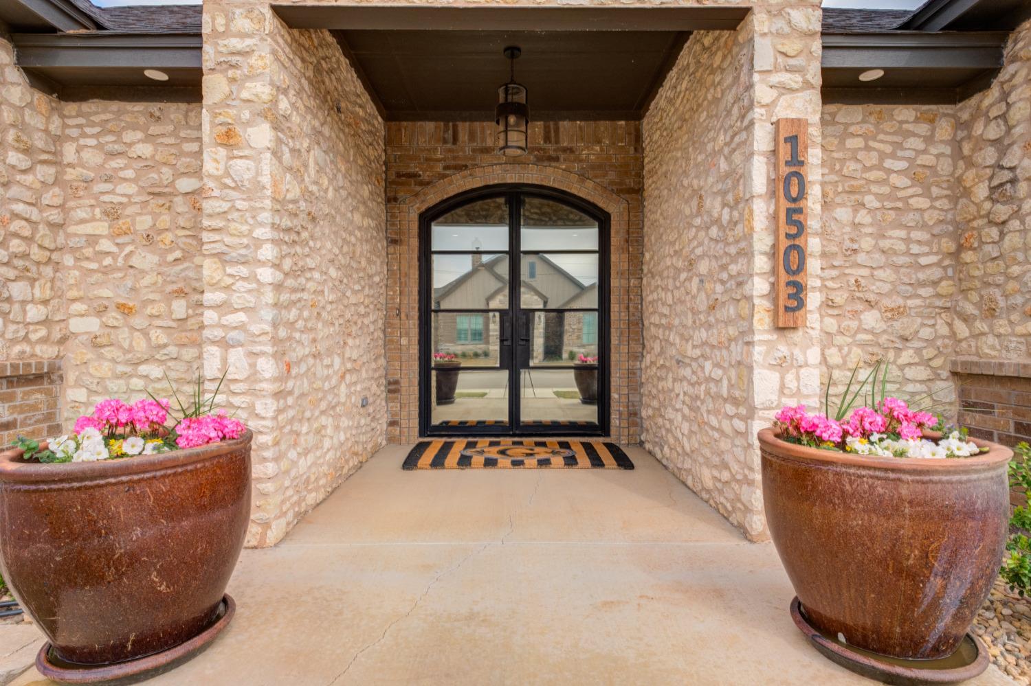 From the moment you drive up you'll fall in love with the exterior stone entryway double iron-paned glass front door! As you step into this fabulous Custom Garden Home you'll feel both at home & in awe of the amazing craftsmanship & designer finishes right out of a magazine. You'll see all the entertaining possibilities this pristine beauty offers. The open floor plan will allow for fluid transitions as your events transpire & open to an inviting courtyard w/hot tub; a perfect place to relax w/family & friends. This home boasts luxurious features 3/3/2, formal dining, wine & coffee nook, huge walk-in pantry, gourmet kitchen lots of custom cabinets, breakfast bar, SS  fridge/freezer, 5 burner gas cook top, granite countertops in kitchen, tile (wood look) flooring, spa inspired master suite w/huge walk-in closet. Spacious utility! Spray foam insulation! Water Softener! Mud Room! Floored Attic Storage! Exceptional curb appeal with lush landscaping nestled on an impressive cul-de-sac.