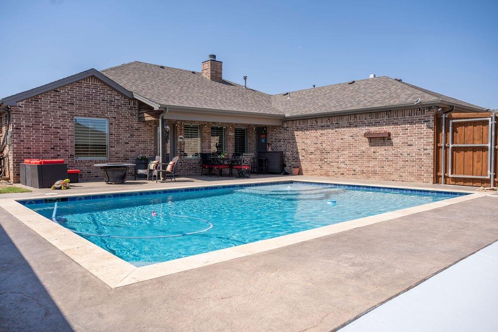 Pool Days await in this lightly lived in Bacon Crest 3/3.5/2 home. Your eye catches the sparkle of the pristine pool and tanning ledge as you enter the light & bright open concept main living space. The dream kitchen is ready to host your next gathering with a built in refrigerator, gas cook top and large pantry. There are 3 isolated bedrooms each with their own bath; two bedrooms offer en-suites and one bedroom is adjacent to the hall bath. An additional half bath serves for guests and offers access to the patio/ pool area. The spacious Basement is a great place to relax and enjoy movie night. A huge utility room offers a sink & extra storage. The mudroom space is next to the utility room, garage entrance door and offers a bench with storage. Storage space abounds in the oversized 2 car garage. The backyard offers a small grass area + the gorgeous POOL! (Pool: 2021 install, Gas heating, Self-cleaning system) Great Curb Appeal & Frenship ISD! Convenient to Marsha Sharp Fwy & Loop 289.