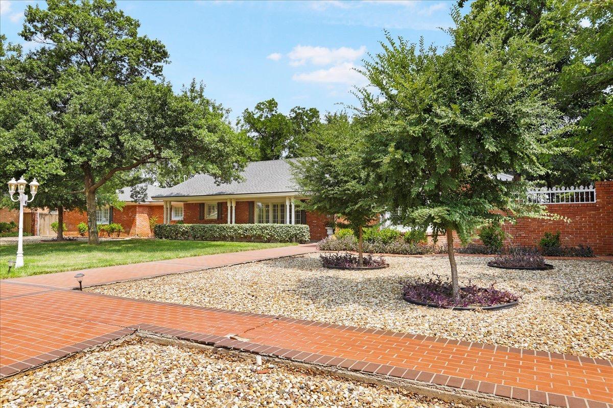 Stunning Curb Appeal on this beauty near Lubbock Christian University. This gorgeous home sits on an oversized lot and provides plenty of parking for multiple cars and recreational vehicles. A privacy gate across the driveway offers lots of security. Inside you will find 4 VERY LARGE Bedrooms, 2 Master Bedrooms, 3 1/2 Bathrooms, multiple living spaces, dining areas, sunroom and updated kitchen! Outside there is a 3 car garage attached to a massive shop area that totals 1,654 square feet combined. Brand New Flooring!